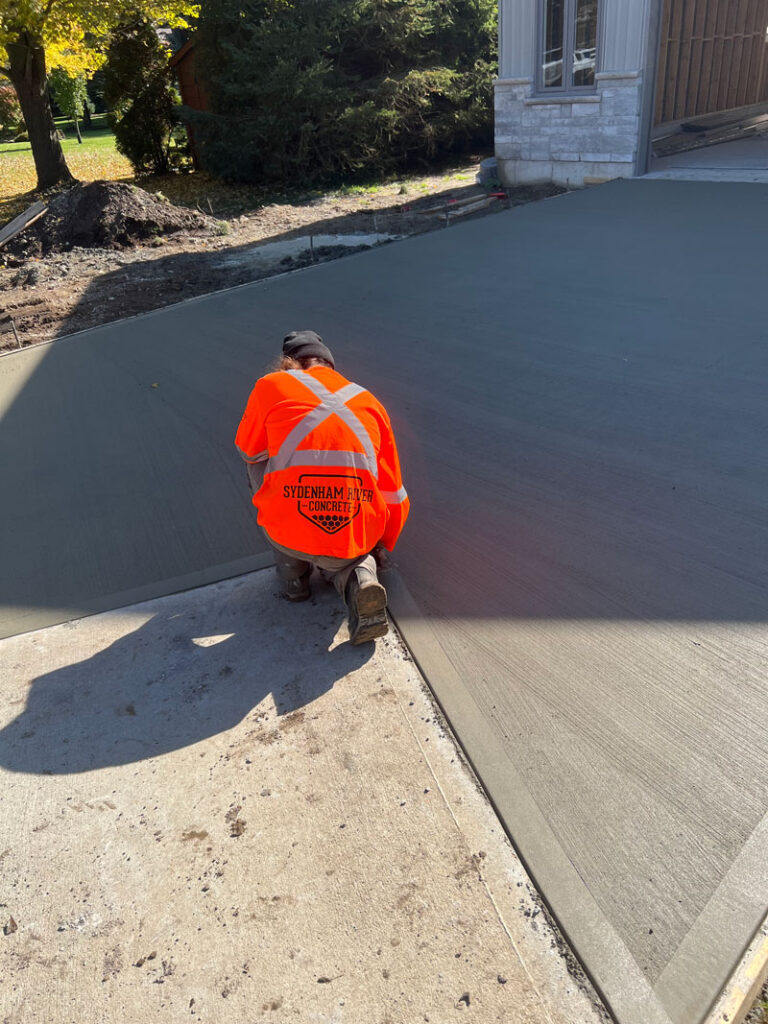 Man finishing edging on a concrete slab