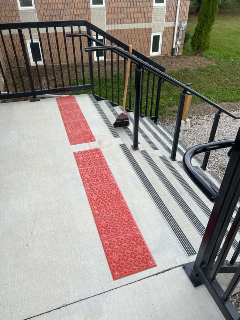 Cement steps with accessible tactile paving.